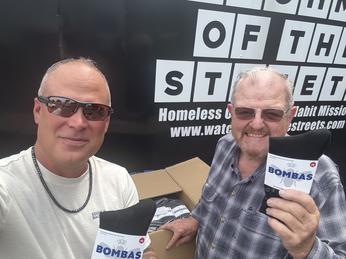 Volunteers with boxes of donated socks at the trailer